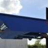 Blue low tipping body on forklift truck